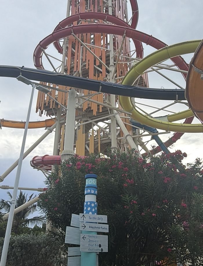 Looking up at Daredevil's Tower at Thrill Waterpark, Perfect Day at CocoCay, with red, yellow and orange slides.