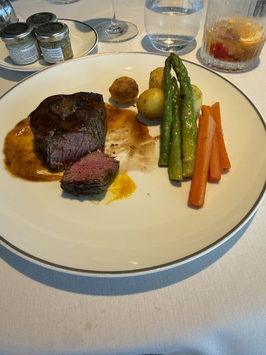 A beef filet topped with truffle, with roasted potatoes, asparagus and carrots, in the MSC Yacht Club restaurant on MSC Seashore