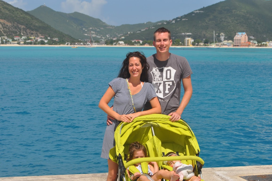 Joey and his wife on a family cruise with turquoise water in the background.